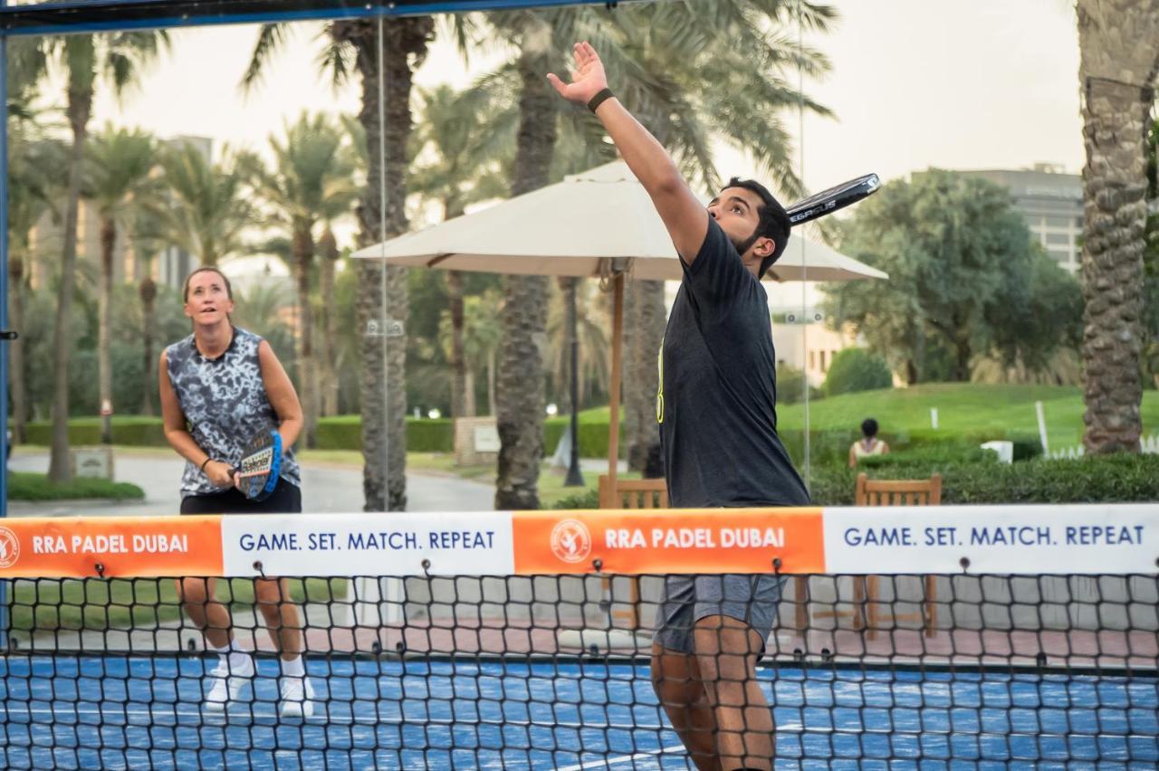Park Hyatt Dubai Hotel Exterior photo A player serves in a paddle tennis match